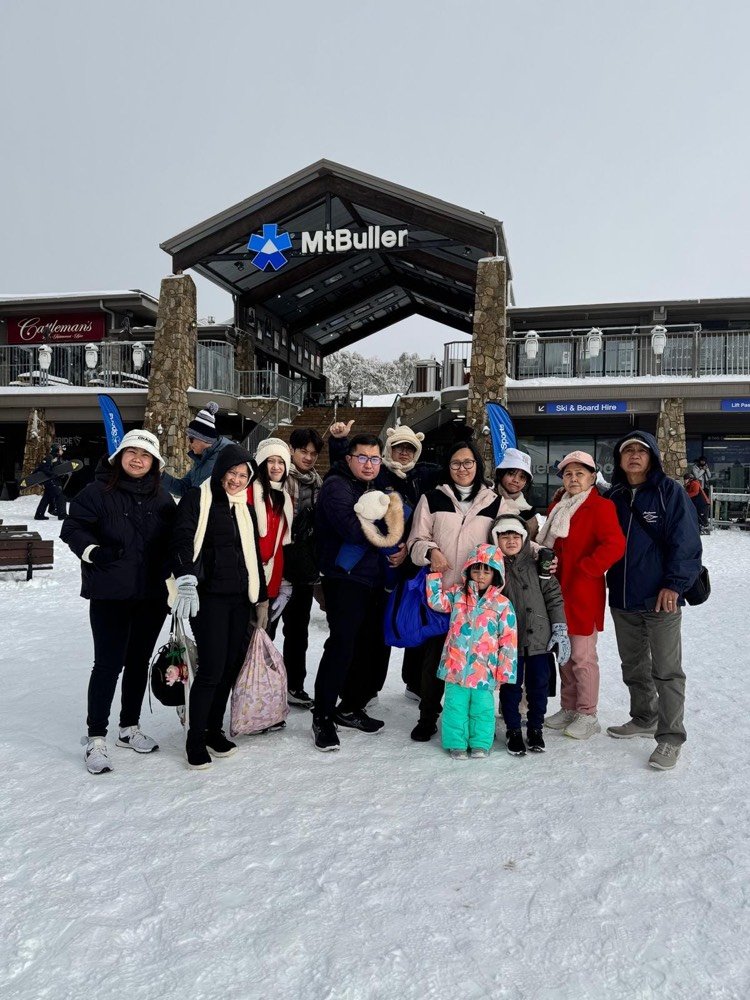 A tour group in the snow at Mt Buller village