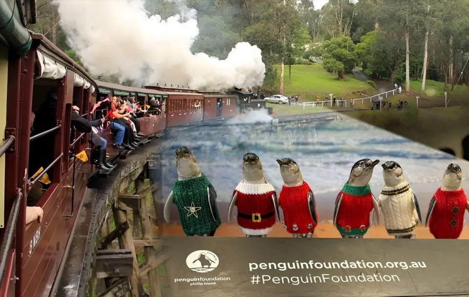 The Puffing Billy steam train beside penguin figures